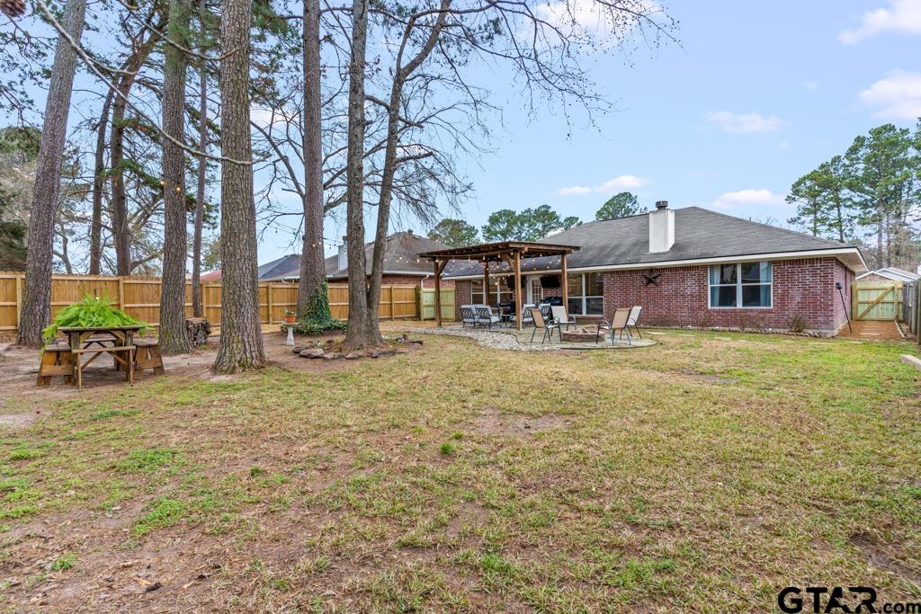 270 Frederick Circle Flint, TX 75762 - Photo 28 of 34 a front view of a house with large trees and lawn chairs