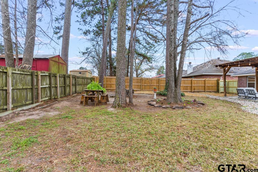 270 Frederick Circle Flint, TX 75762 - Photo 30 of 34 a view of a yard with table and chairs and a large tree