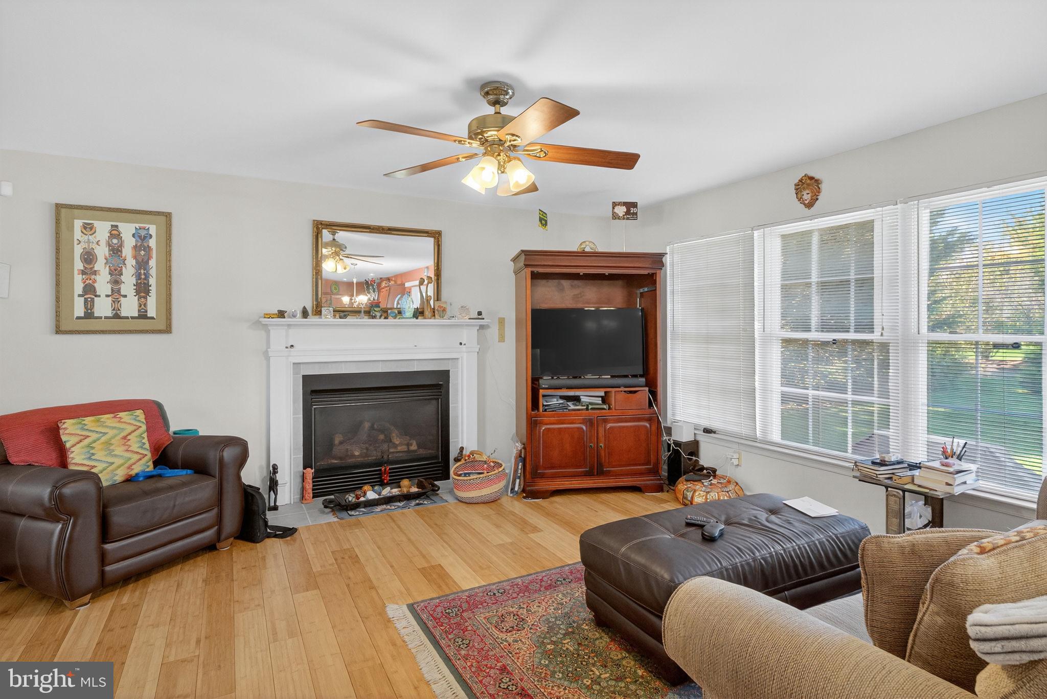 6779 Hickory Road Macungie, PA 18062 - Photo 16 of 51 a living room with furniture a fireplace and a flat screen tv
