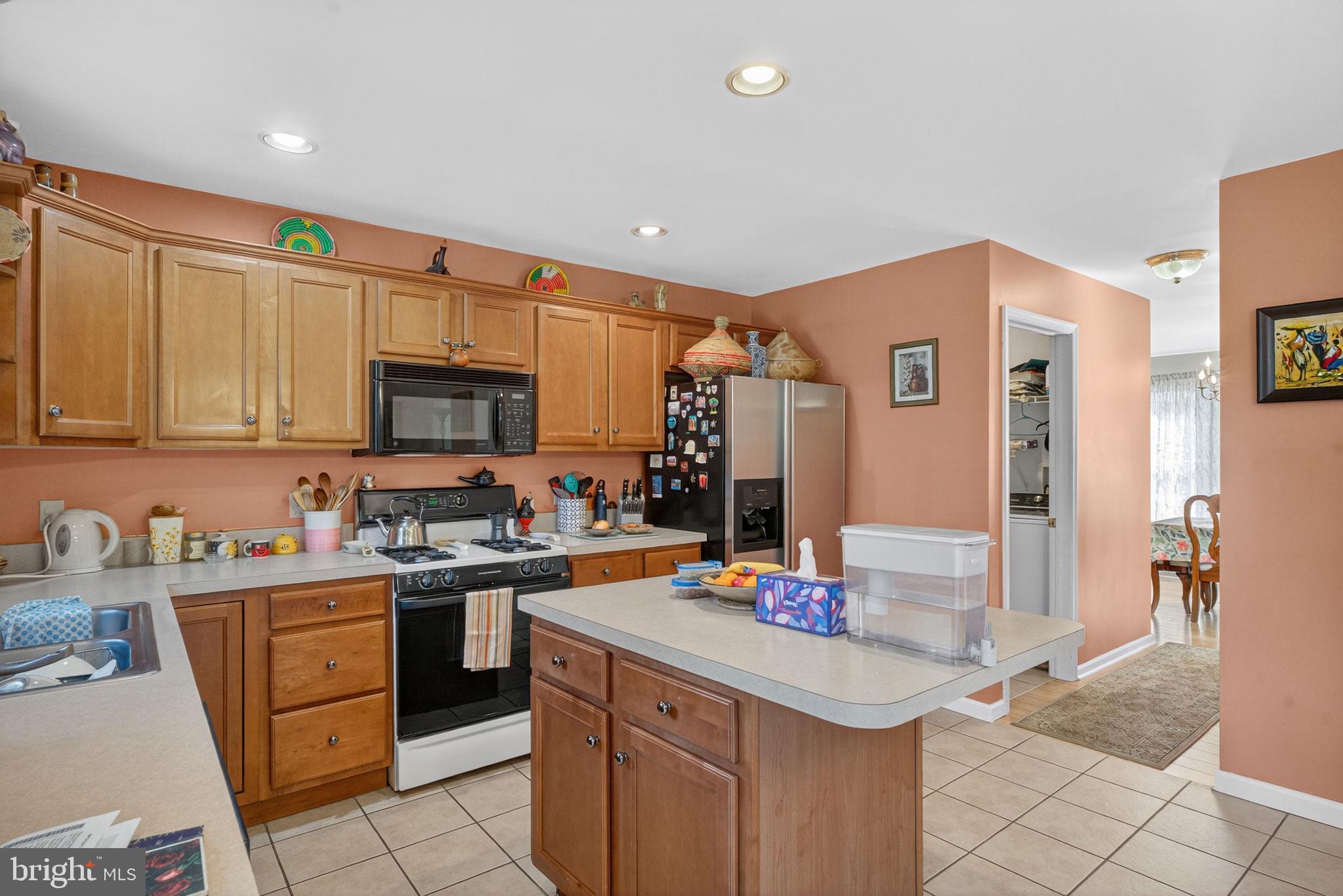6779 Hickory Road Macungie, PA 18062 - Photo 19 of 51 a kitchen with stainless steel appliances granite countertop a sink stove and refrigerator