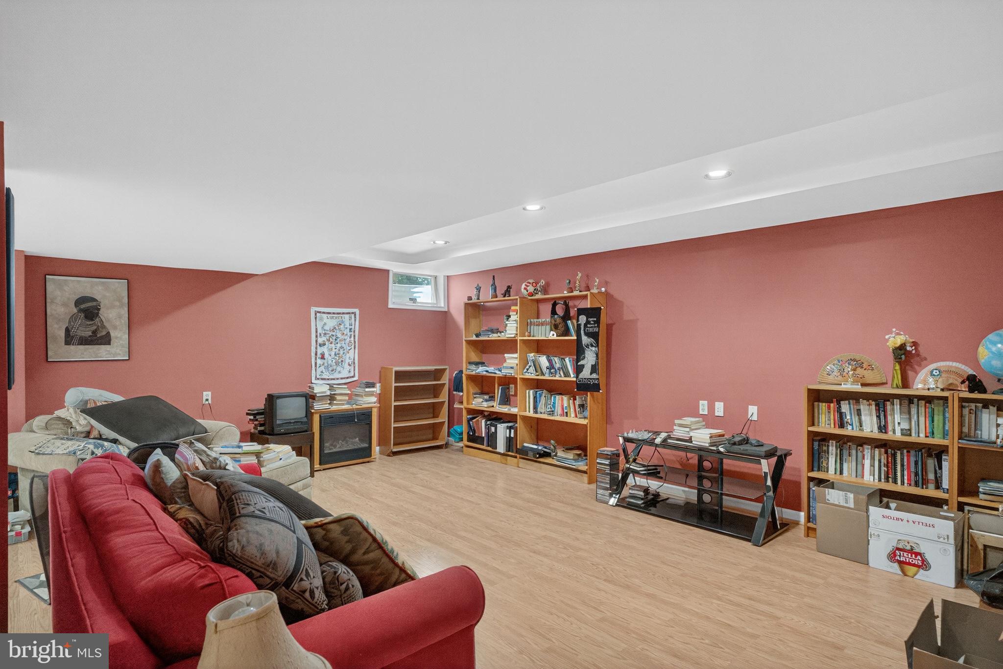 6779 Hickory Road Macungie, PA 18062 - Photo 24 of 51 a living room with furniture a bookshelf and a wooden floor