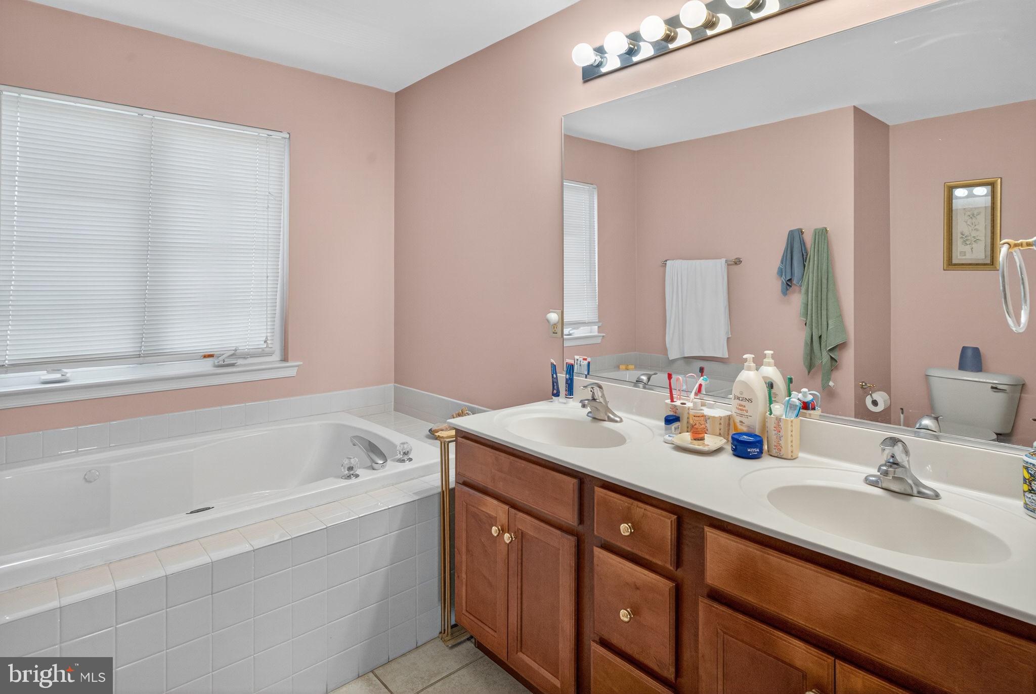 6779 Hickory Road Macungie, PA 18062 - Photo 27 of 51 a bathroom with a tub sink and mirror
