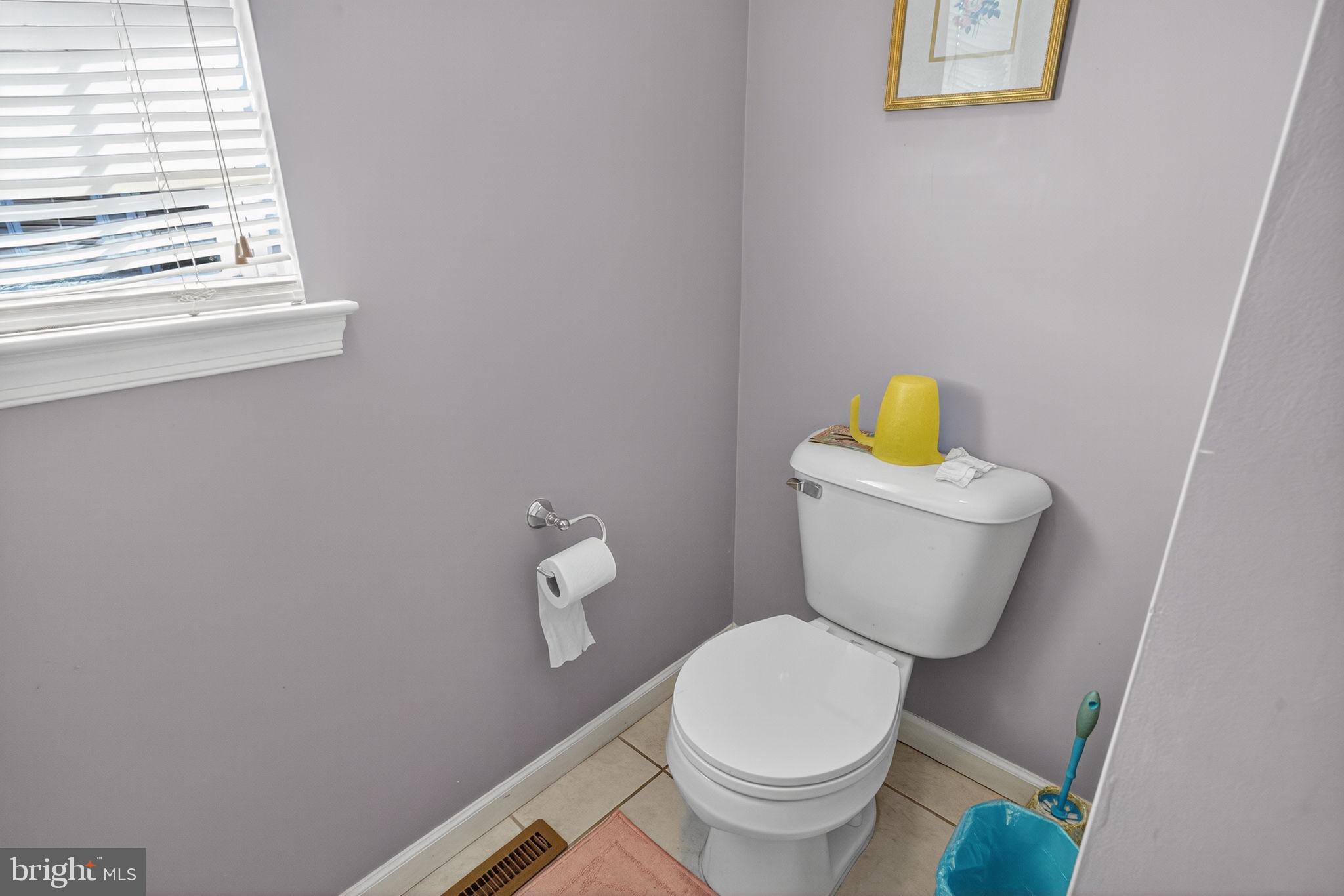 6779 Hickory Road Macungie, PA 18062 - Photo 39 of 51 a white toilet sitting next to a bathroom sink and a window