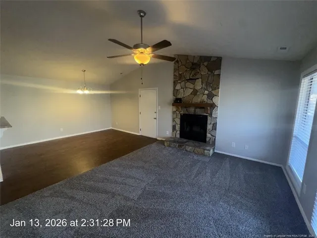 a view of an empty room with a kitchen