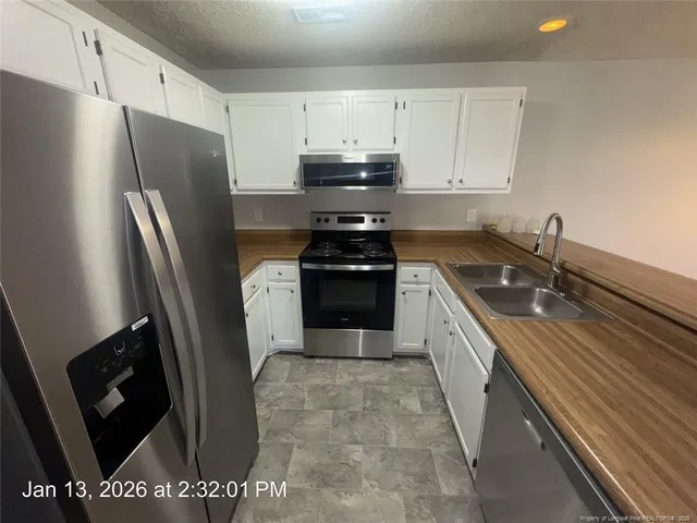 an empty room with windows and ceiling fan