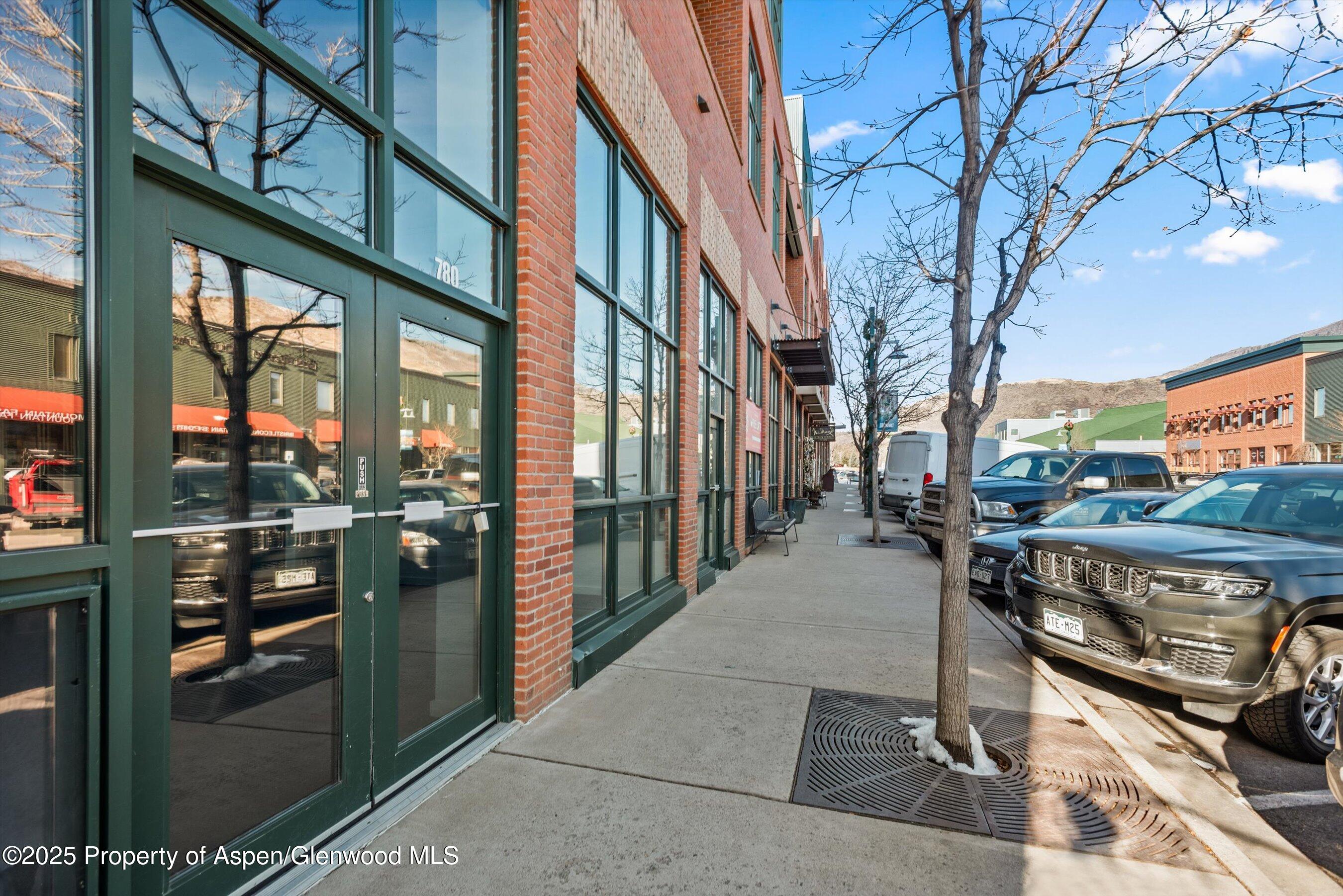 a view of a patio with a table and chairs and potted plants