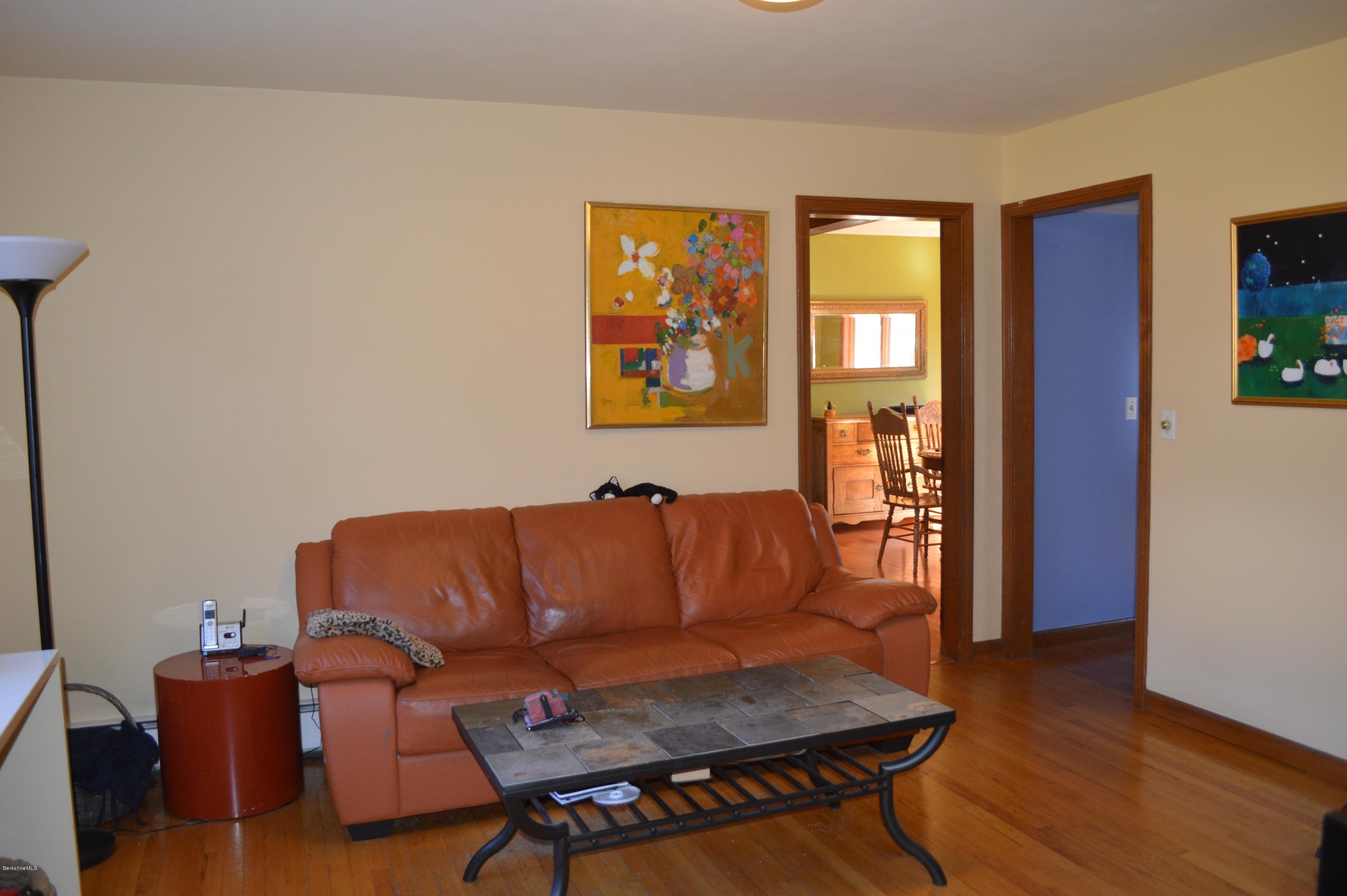 485 Devon Road Lee, MA 01238 - Photo 8 of 28 a blue couch sitting in a living room next to a window