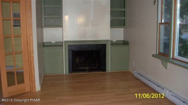 121 Rhododendron Lane Milford, PA 18337 - Photo 3 of 7 a view of an empty room with a fireplace and window