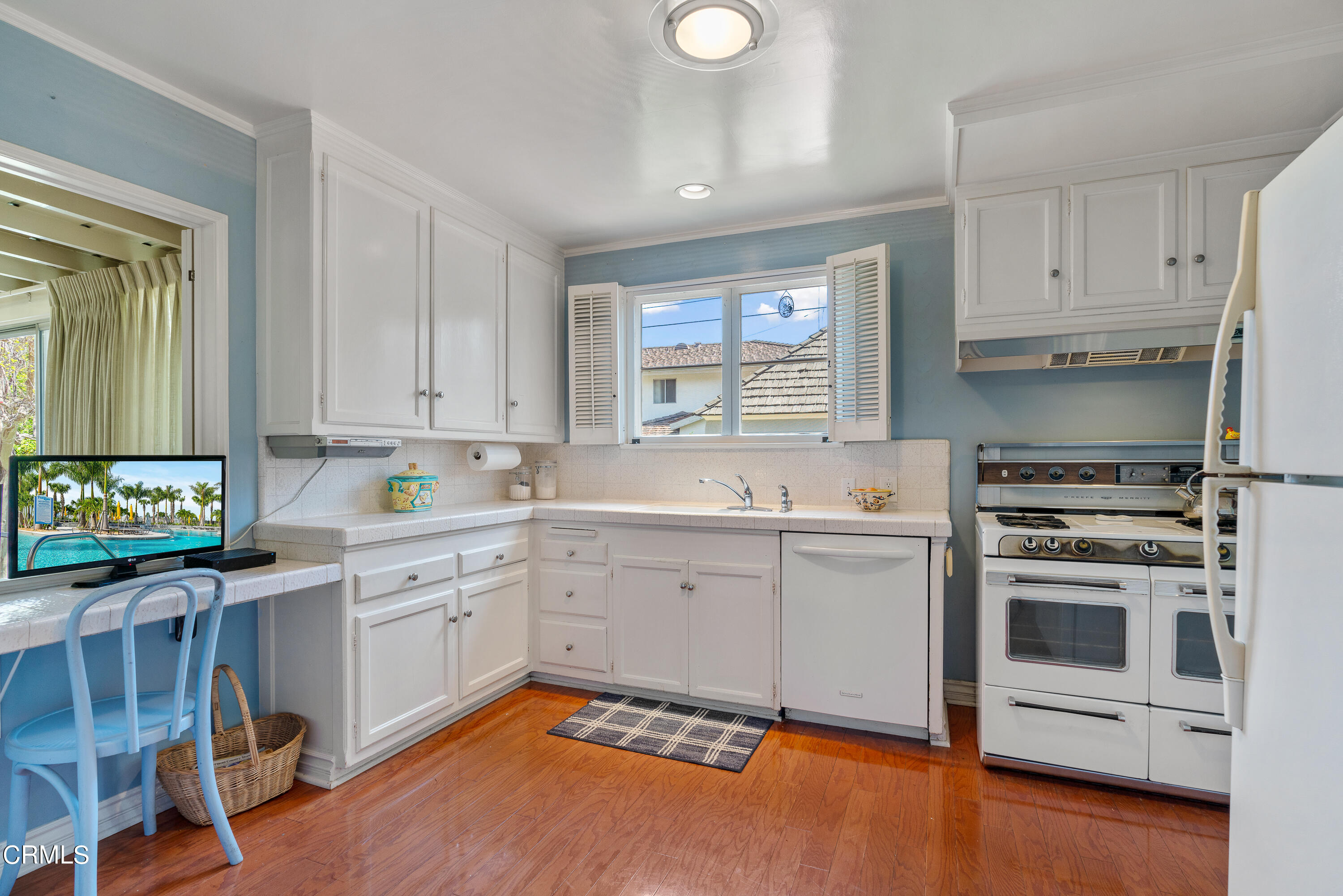 724 Winthrop Road San Marino, CA 91108 - Photo 14 of 37 a kitchen with a stove white cabinets and a window