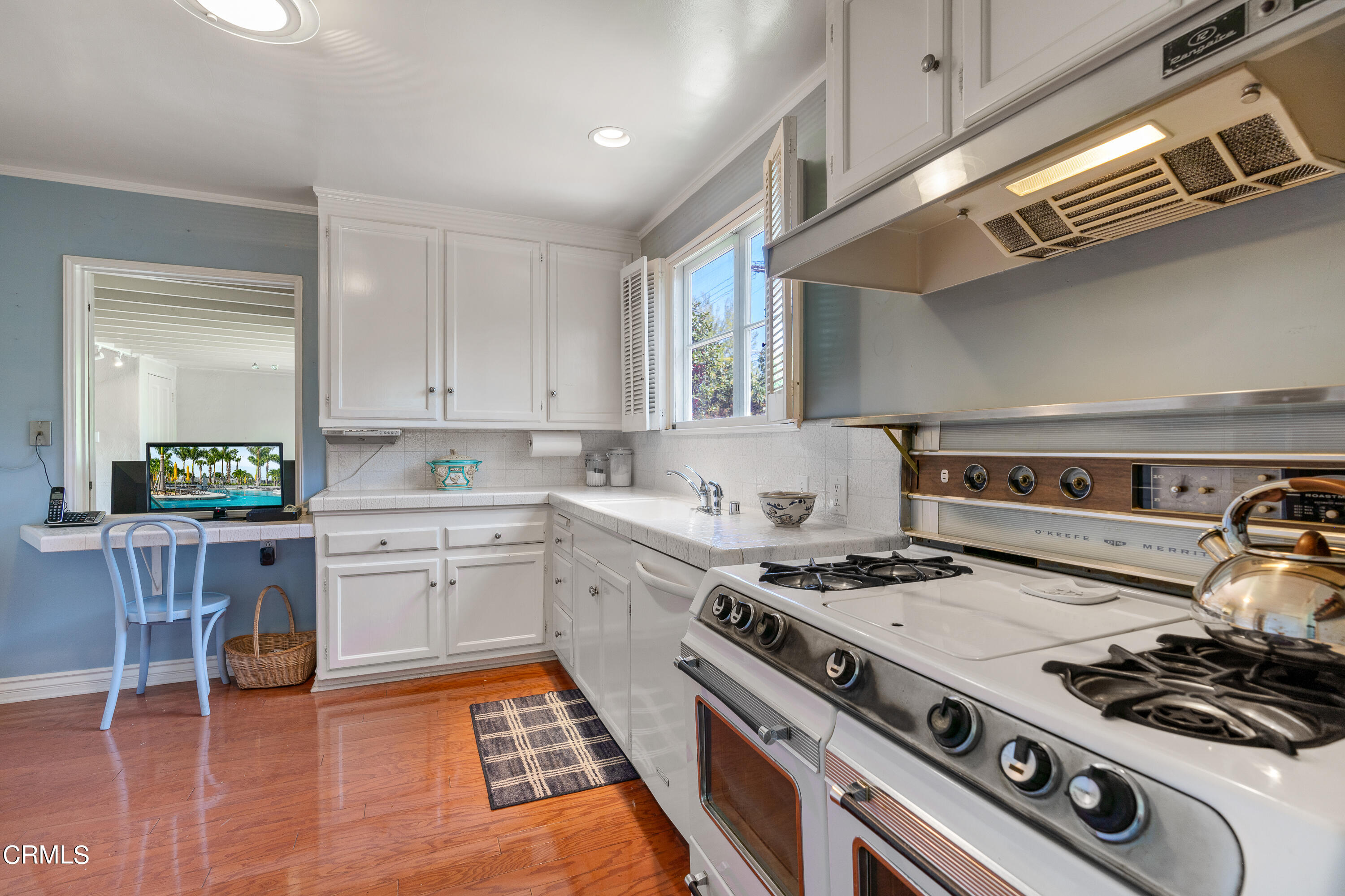 724 Winthrop Road San Marino, CA 91108 - Photo 15 of 37 a kitchen with a stove and a white wooden cabinets