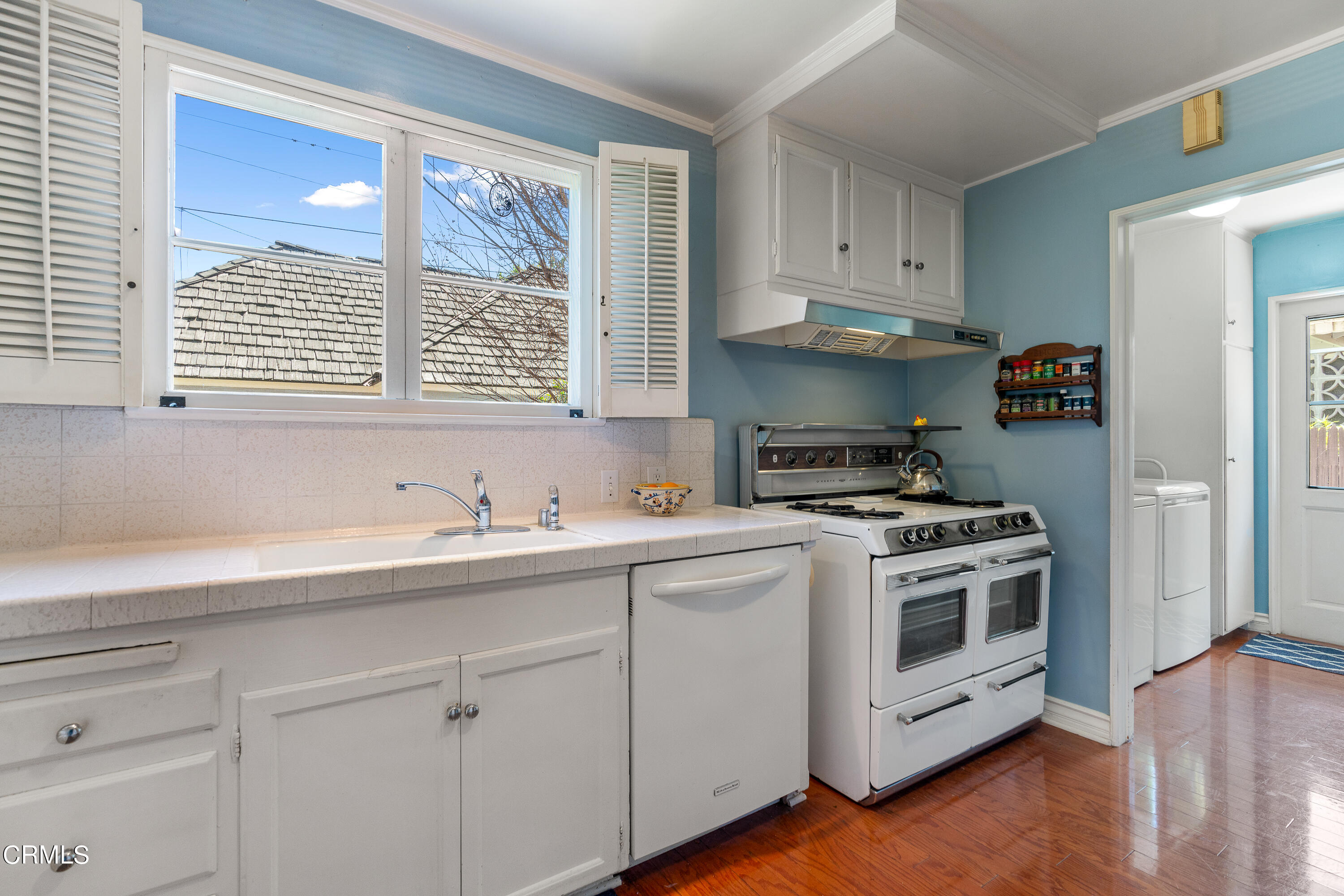 724 Winthrop Road San Marino, CA 91108 - Photo 16 of 37 a kitchen with stainless steel appliances white cabinets and a stove top oven