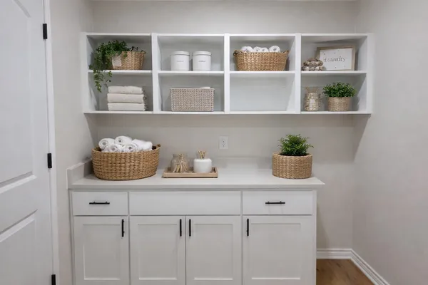 a kitchen with white cabinets and a wooden floor