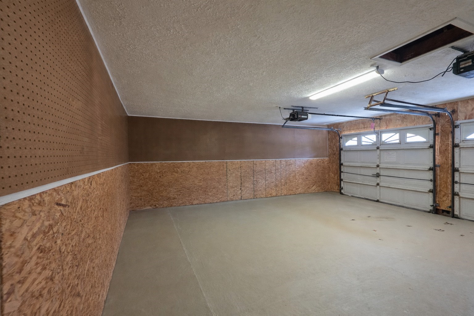 8708 West Fox Road Orange, TX 77632 - Photo 14 of 23 This spacious garage features a concrete floor, double doors with windows for natural light, and pegboard walls for easy tool organization. Ideal for parking and storage.
