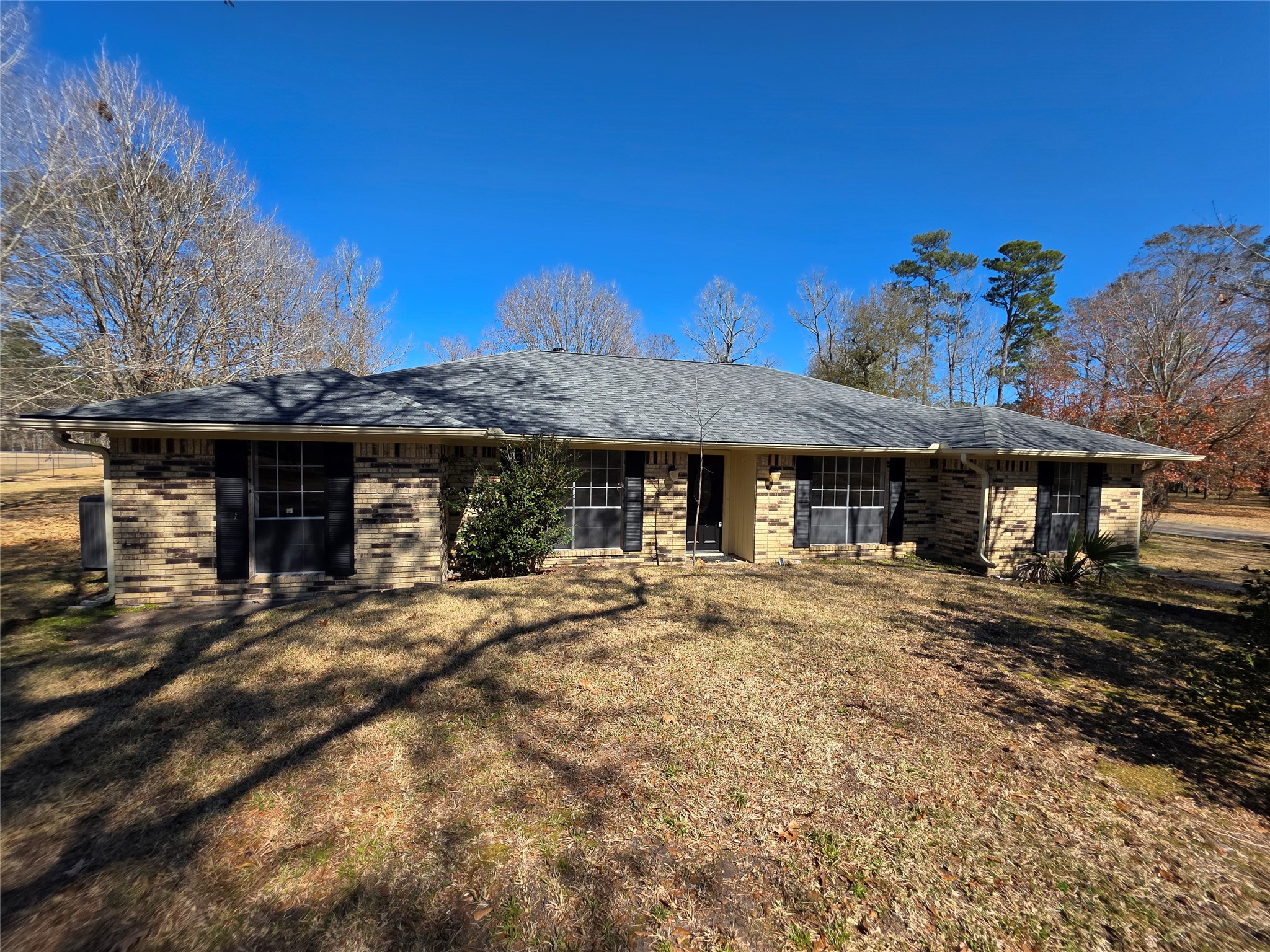 8708 West Fox Road Orange, TX 77632 - Photo 16 of 23 Charming single-story brick home with a spacious front yard and mature trees. The property features a classic ranch-style design with large windows for natural light. Perfect for those seeking a serene, suburban setting.