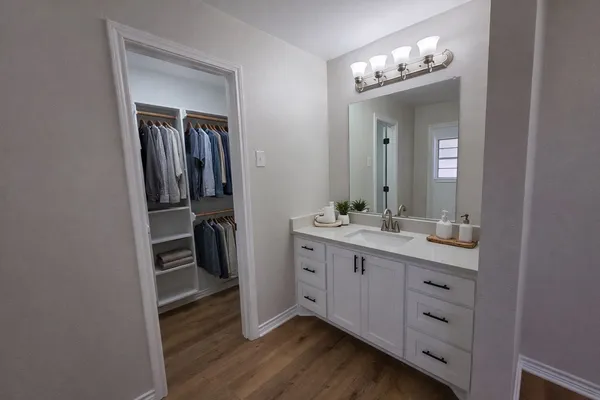 a bathroom with a double vanity sink and a mirror