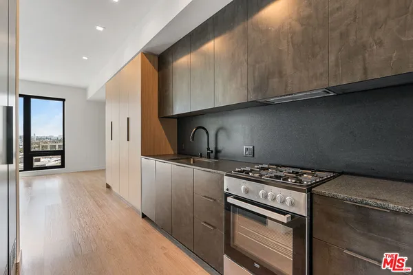 a kitchen with granite countertop a stove and a sink