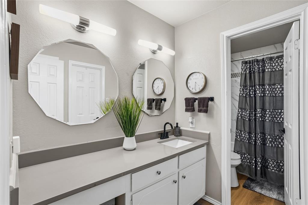 5540 Boca Raton Boulevard, Unit 181 Fort Worth, TX 76112 - Photo 15 of 21 Double vanity featuring a light gray countertop with an integrated sink and matte black faucet