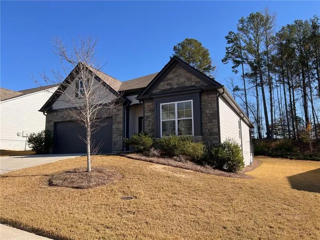 a front view of a house with garden