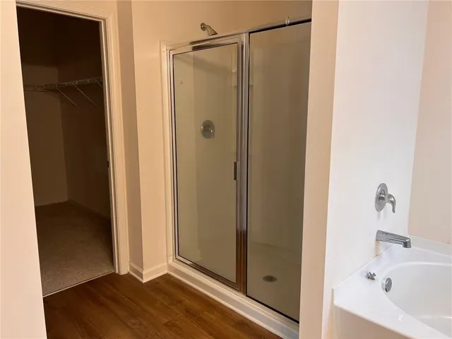 a bathroom with a bathtub and a shower