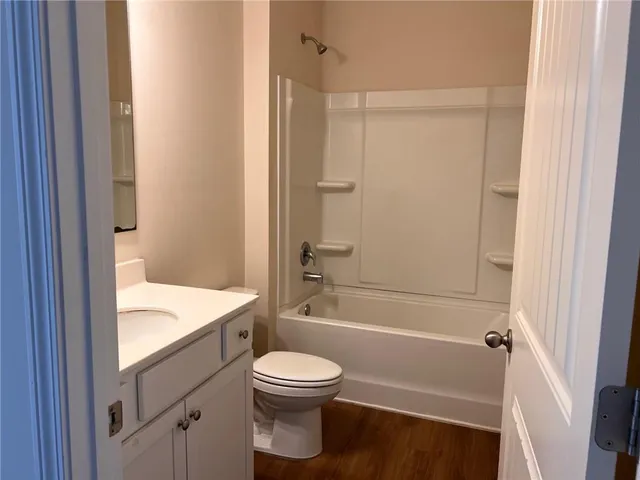 a bathroom with a toilet a sink and bathtub