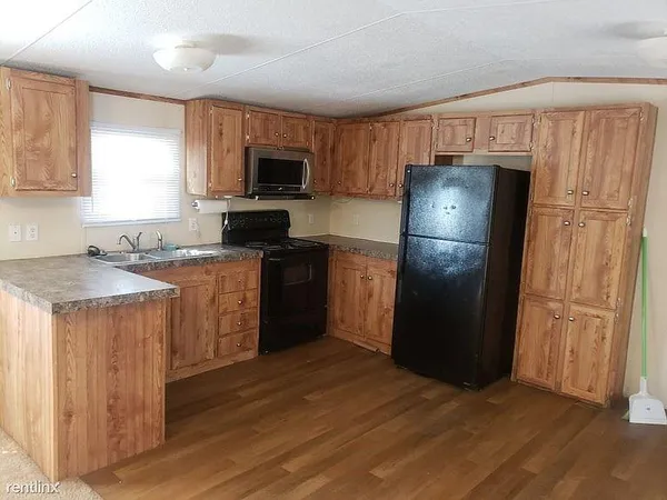 a kitchen with a refrigerator sink and microwave