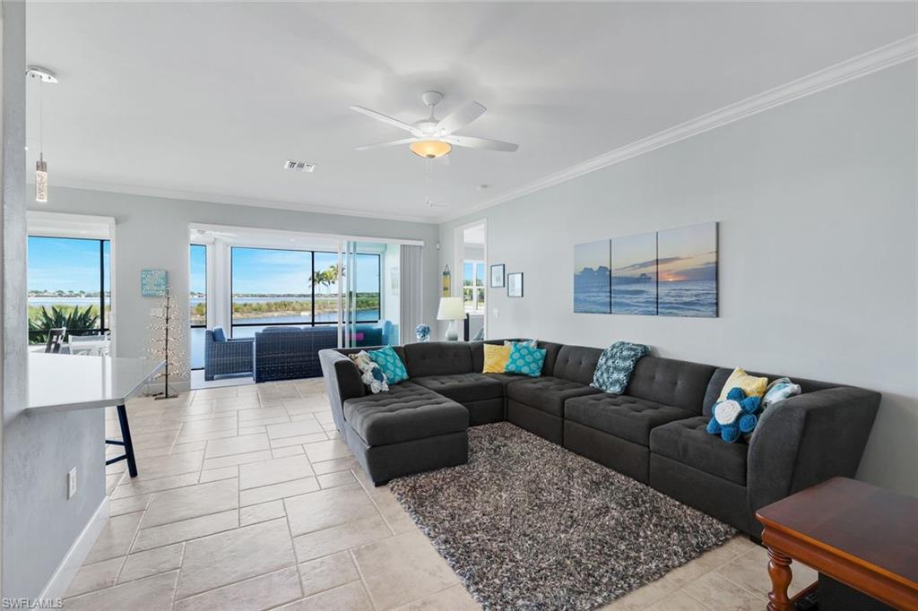 9060 Siesta Bay Drive, Unit 101 Naples, FL 34120 - Photo 15 of 49 a living room with furniture and a couch