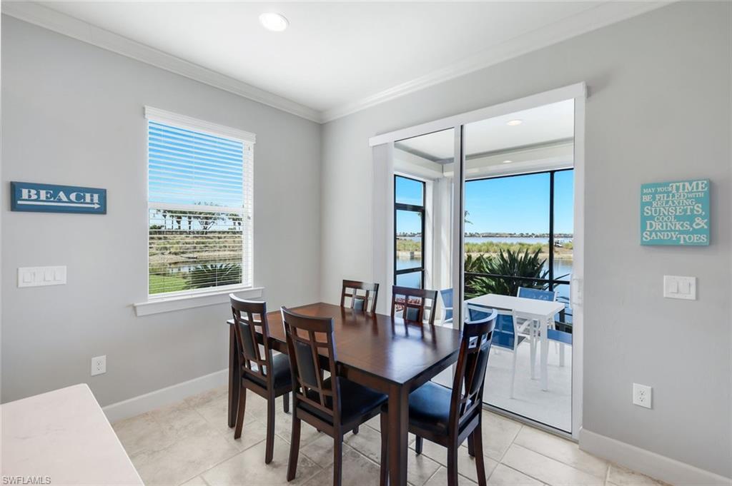 9060 Siesta Bay Drive, Unit 101 Naples, FL 34120 - Photo 20 of 49 a view of a dining room with furniture window and outside view