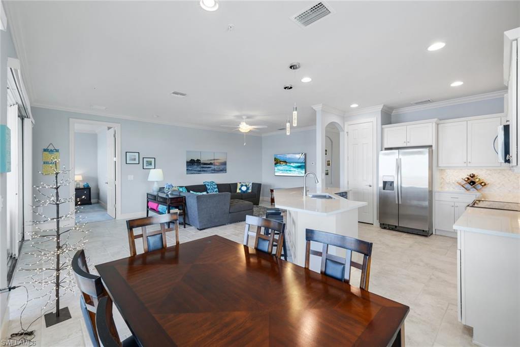 9060 Siesta Bay Drive, Unit 101 Naples, FL 34120 - Photo 21 of 49 a living room with lots of furniture and kitchen view