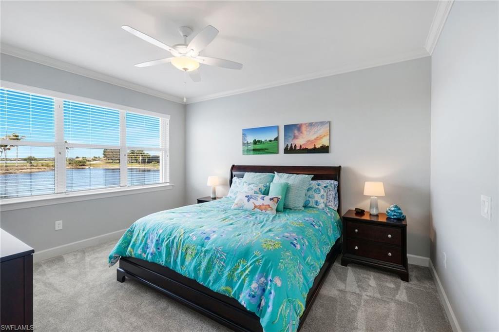9060 Siesta Bay Drive, Unit 101 Naples, FL 34120 - Photo 22 of 49 a bedroom with a bed and a large window