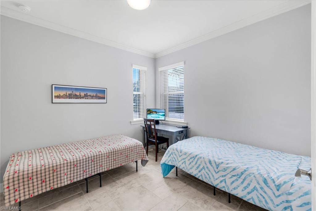 9060 Siesta Bay Drive, Unit 101 Naples, FL 34120 - Photo 28 of 49 a bedroom with a bed and window