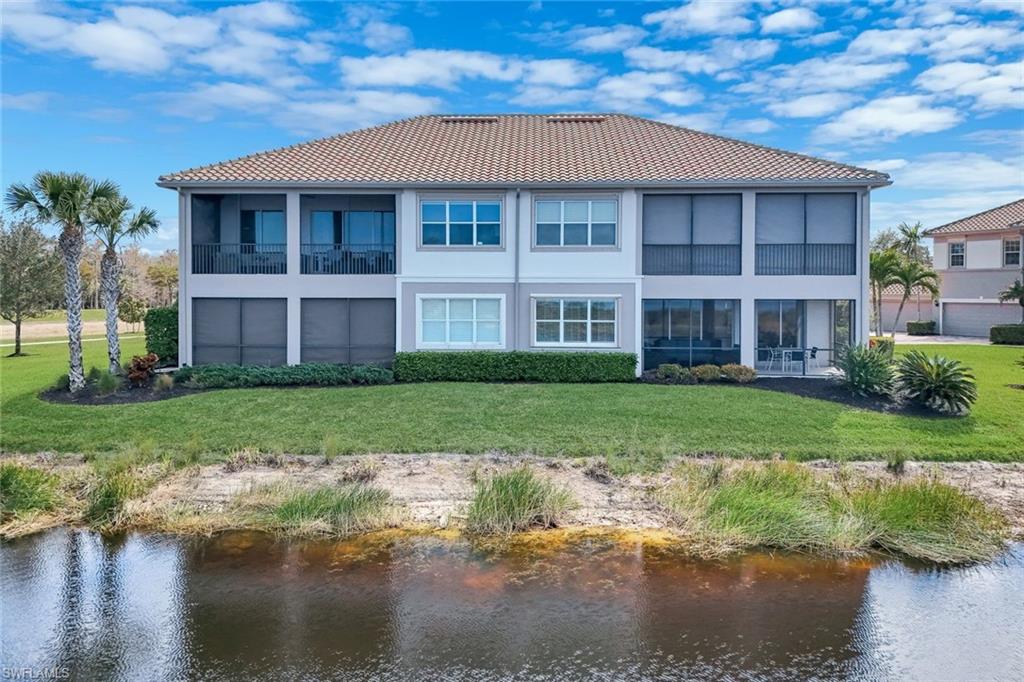 9060 Siesta Bay Drive, Unit 101 Naples, FL 34120 - Photo 29 of 49 a front view of a house with a yard