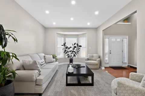 a living room with furniture potted plant and a window