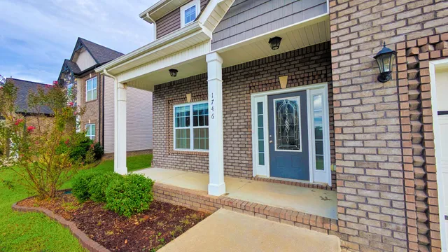 a front view of a house with a garden