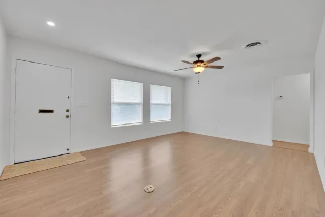 wooden floor in an empty room with a window