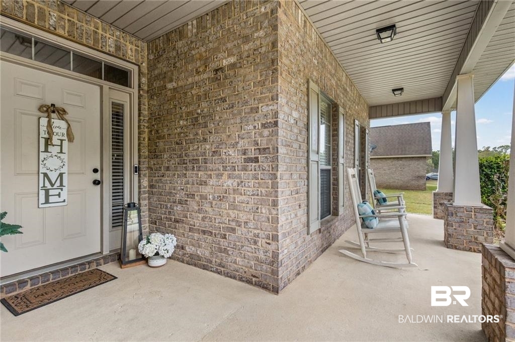 2570 Pecan Pointe Drive Semmes, AL 36575 - Photo 2 of 22 Doorway to property featuring brick siding and a porch