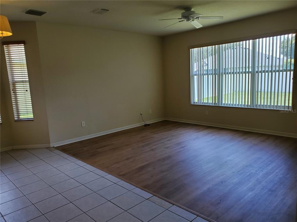 5584 Southwest 39th Street Ocala, FL 34474 - Photo 11 of 56 an empty room with wooden floor and windows