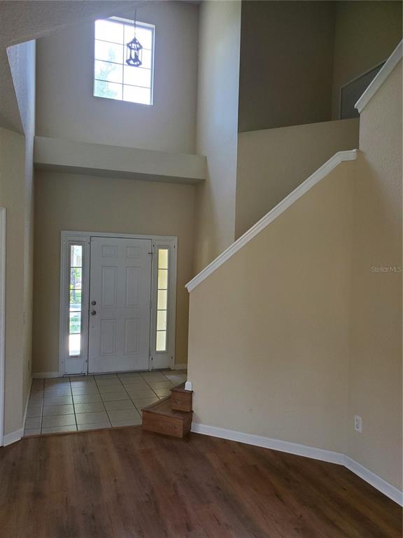 5584 Southwest 39th Street Ocala, FL 34474 - Photo 12 of 56 a view of a hallway with wooden floor and a living room