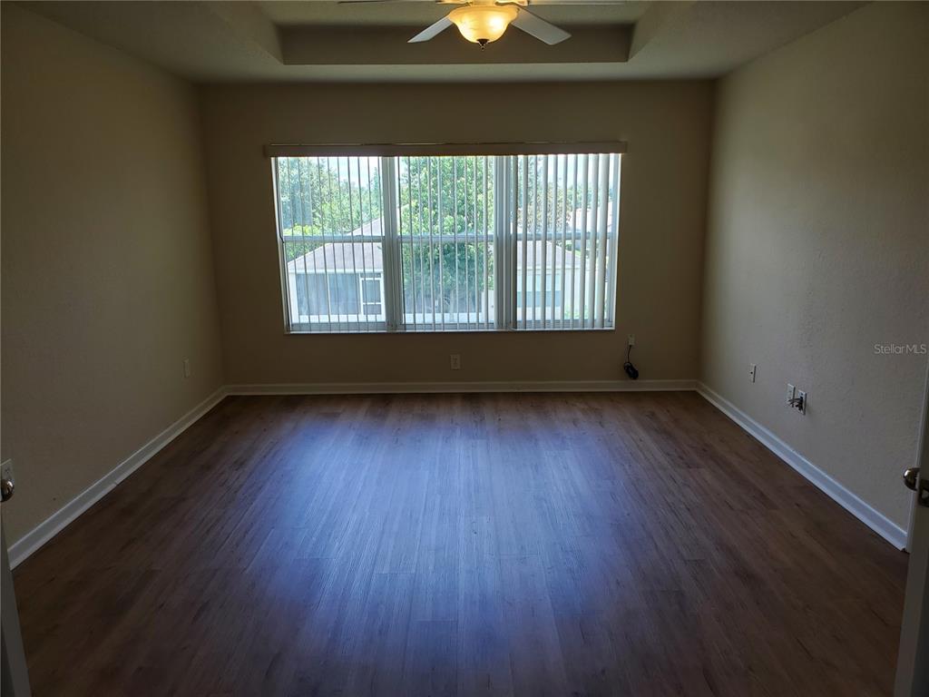 5584 Southwest 39th Street Ocala, FL 34474 - Photo 19 of 56 a view of an empty room with wooden floor and a window