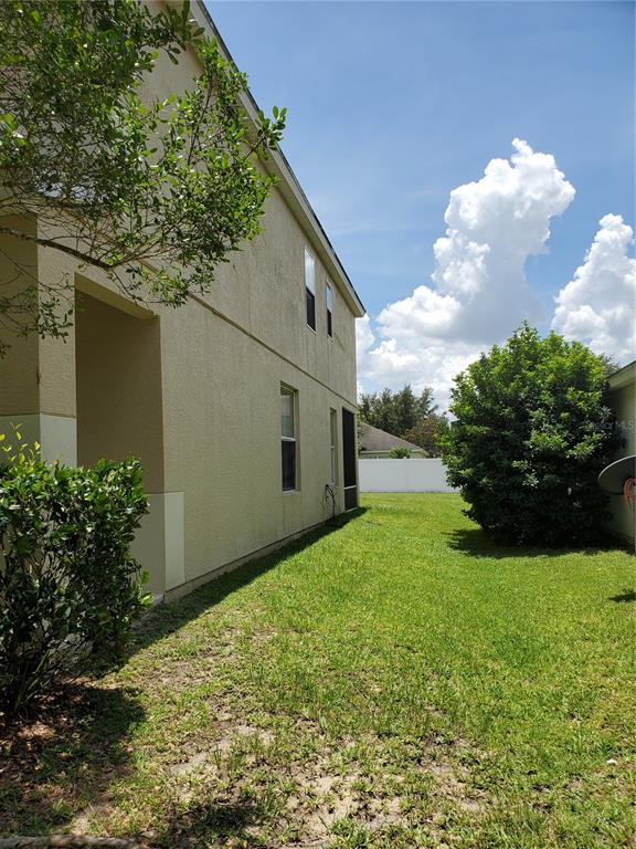 5584 Southwest 39th Street Ocala, FL 34474 - Photo 2 of 56 a backyard of a house with lots of green space