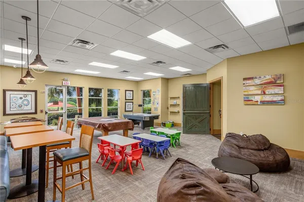 a living room with furniture fireplace and large windows