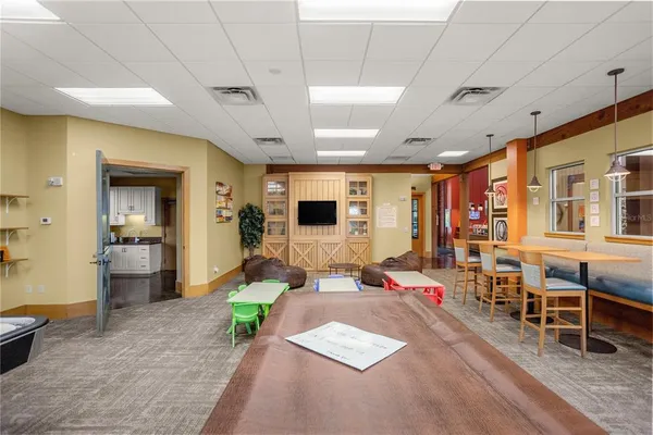 a living room with furniture gym equipment and a large window