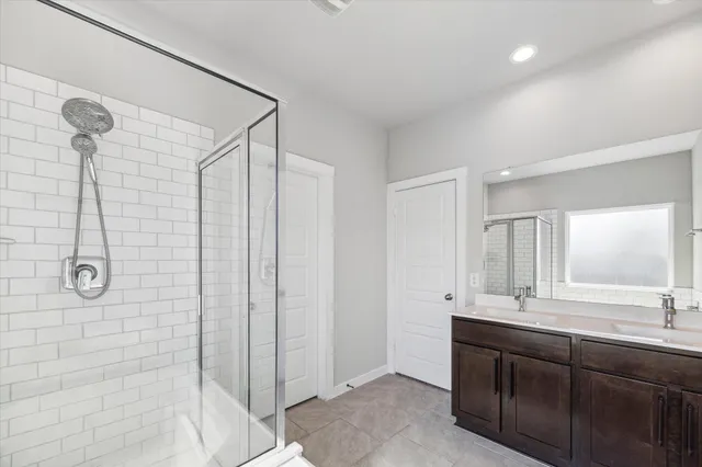 a bathroom with a shower sink and mirror