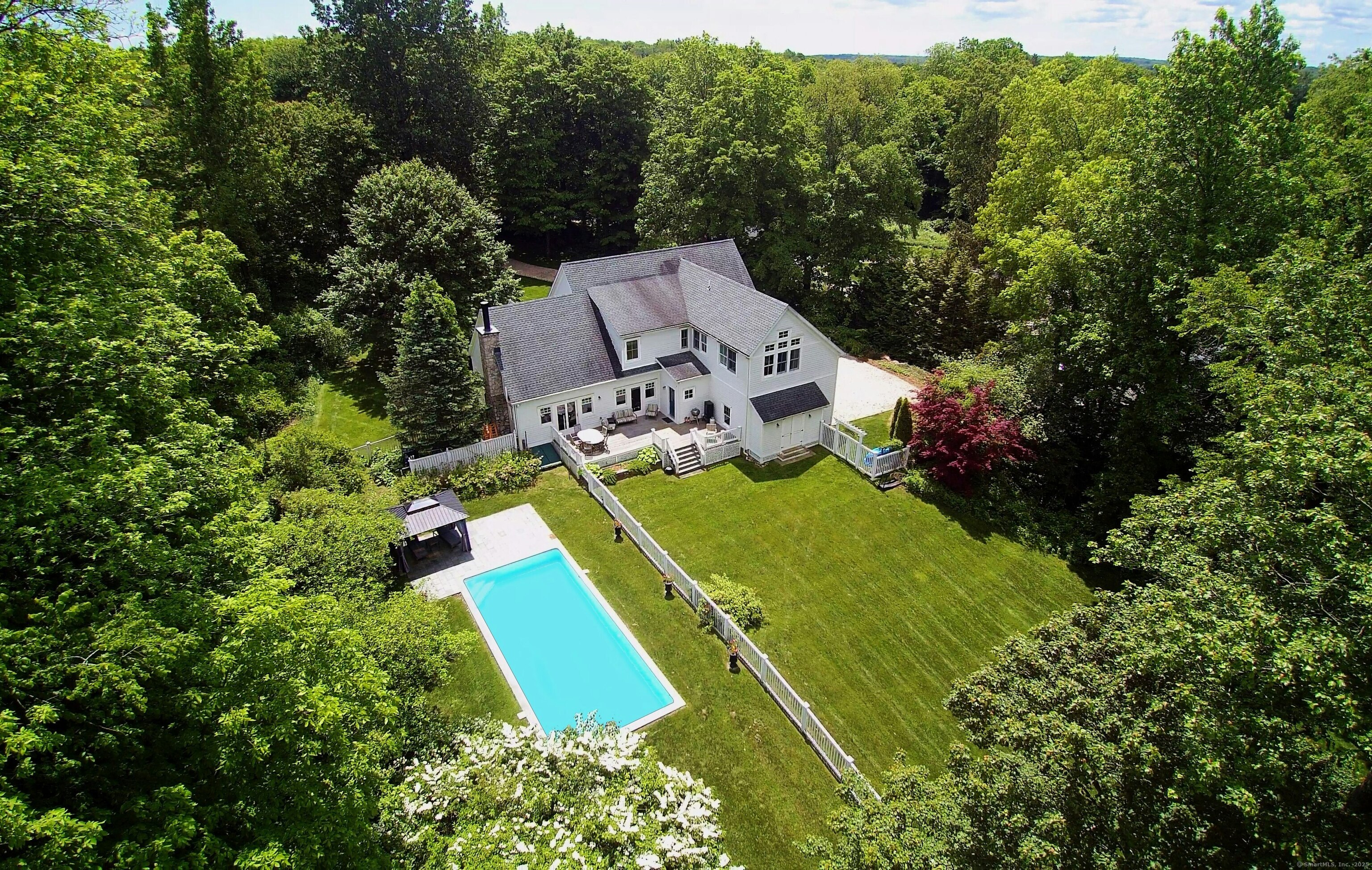 an aerial view of a house with a yard