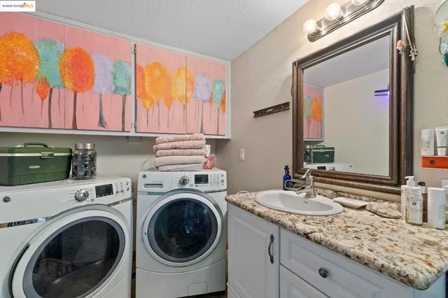 a bathroom with a sink a washer and dryer