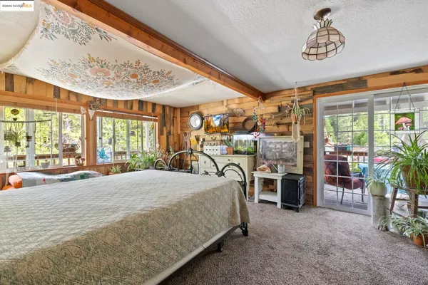 a bedroom with a large bed and a large window