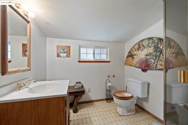a bathroom with a sink a toilet and mirror
