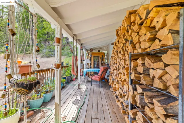 a balcony with wooden floor and outdoor seating