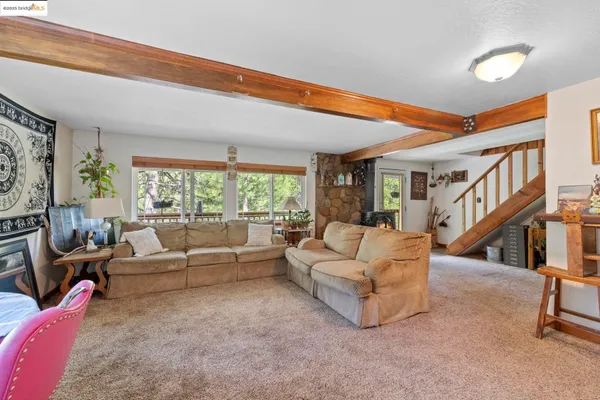 a living room with furniture a ceiling fan and a window