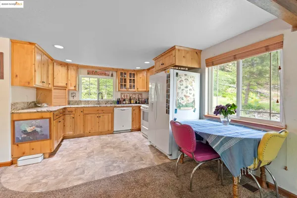 a large kitchen with a large window and wooden cabinets