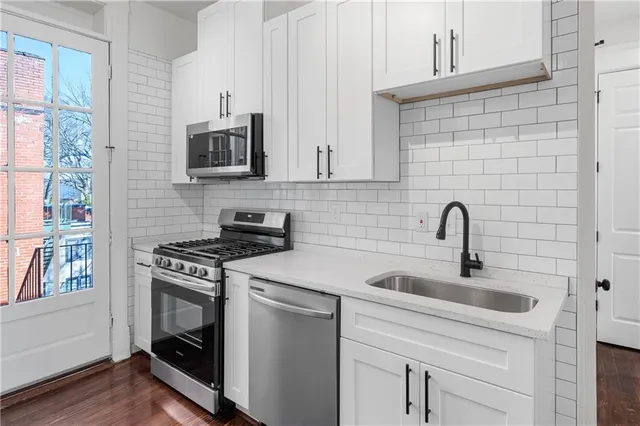 a kitchen with cabinets a sink and a stove top oven